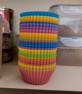Rainbow coloured silicon muffin cases stacked in random order. This is very, very wrong.